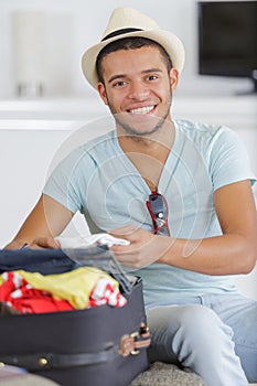 young man preparing for vacation travel