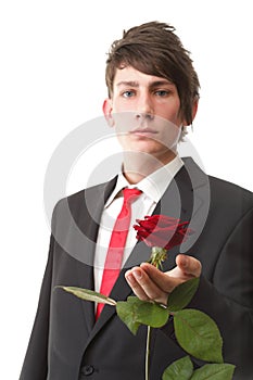 Young man presenting a flower red rose isolated