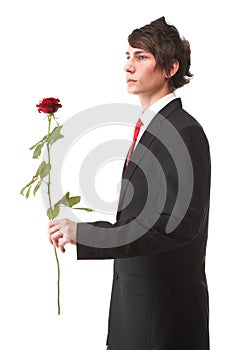 Young man presenting a flower red rose isolated