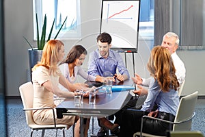 Young man presenting ideas to his business team