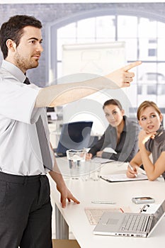 Young man presenting in meeting room