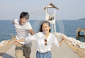 Young man and pretty woman joyful emotion and playing at sea sid