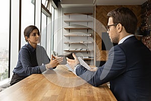 Young man professional lawyer counsel indian woman customer at office photo