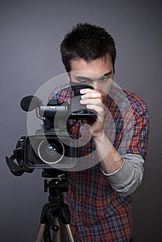 Young man with professional video camcorder