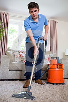 Young Man Professionally Cleaning Carpets photo