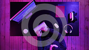 Young man programmer or hacker working on computer at night.