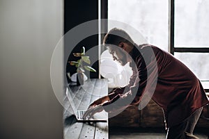 Young man programmer working at computer in office