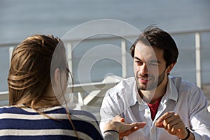 Young man proposing with engagement ring to young woman photo