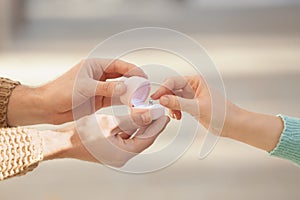 Young man proposing to his beloved at romantic date outdoors