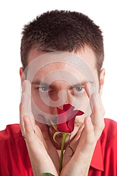 Young man protecting a red rose