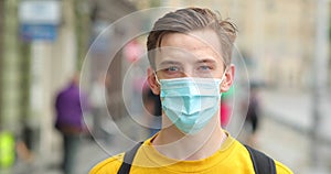 Young man in protective face mask as preventive measure from Chinese coronavirus COVID-19. Hipster man wearing