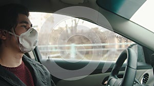 Young man in protective mask driving a car and sharply slows down