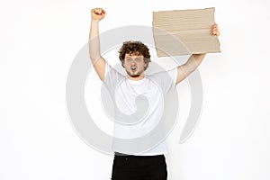 Young man protesting with blank board, sign isolated on white studio background