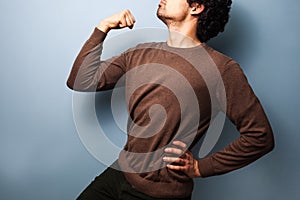 Young man in proud stance with fist raised