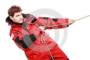 Young man pulling rope.