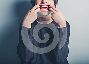 Young man pulling silly faces