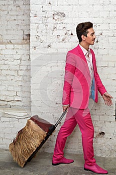 Young man pulls hairy roller bag