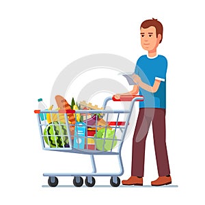 Young man pushing supermarket shopping cart