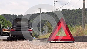 A young man puts an emergency sign