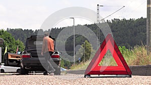 A young man puts an emergency sign