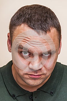 Young man questionably, mistrustfully looking with raised eyebrow