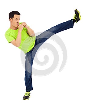 Young man raise leg to kick. martial art concept