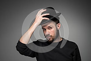 Young man raising his hat in respect and