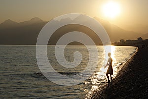 Young man in rays of sun going to swim