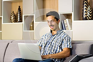 Young man reacting in amazement to a laptop