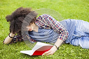 Young man read book in grass