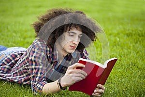 Young man read book in grass