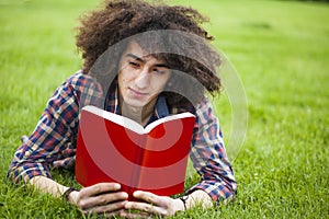 Young man read book in grass