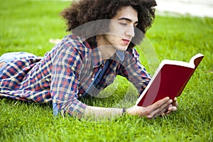 Young man read book in grass