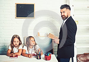 Young man read book for two little girls.