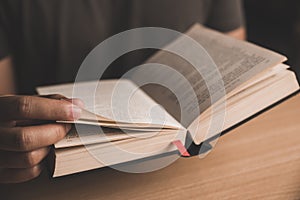 Young man reading a book or holy bible and sharing the gospel.