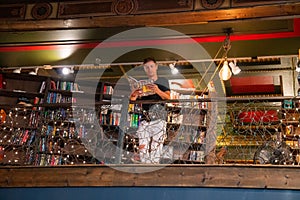 Young man reading a book in the Last Book Store in LA.