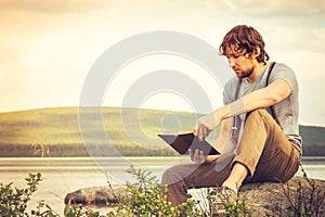 Young Man reading book outdoor Lifestyle