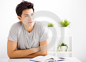 young man reading book and thinking