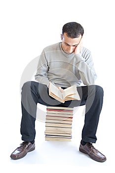 Young man reading a book on white background