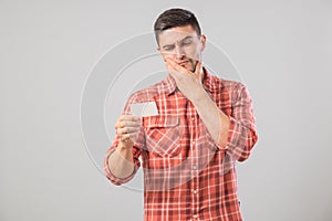 Young man reading business card