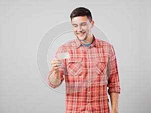 Young man reading business card