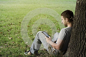 Young man reading e-book