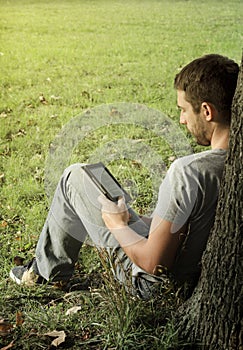 Young man reading e-book