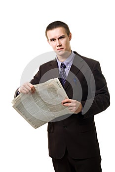 Young man reading newspaper standing photo