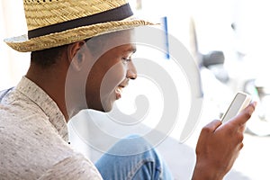 Young man reading text message on cell phone