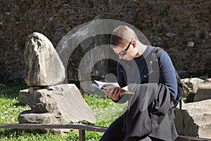 Young man reading a tourist guide