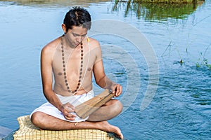 Young man reads ancient scripture.