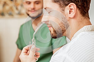 Young man receives nasal inhalation