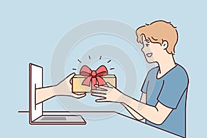 Young man receives present from hand poking out of laptop screen after online shopping. Vector image