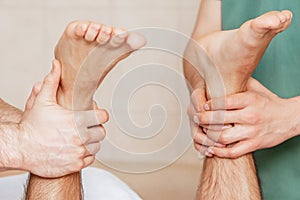 Young man receiving leg massage